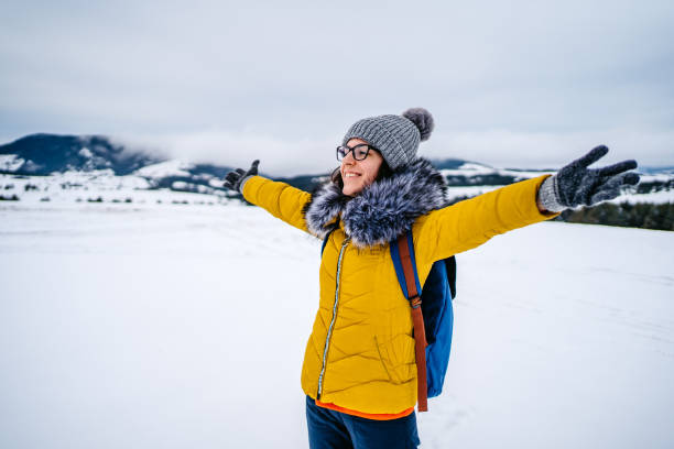 istock Woman with open arms on snowy mountain 1281300371