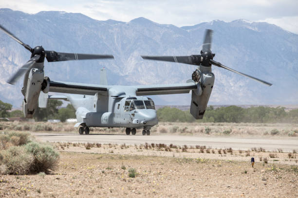 Bishop Airport (KBIH),Bishop California, USA, May 8, 2014.   United States Marine Corps Osprey MV-22 Aircraft from Marine Squadrons, VMM-161 and VMM-162 perform high altitude landing and launching training.Bishop Airport, (KBIH)  was built in 1928 and expanded and operated by the Army Air Corps during WWII.  During the war it was used as a military flight training base and boasted a chow hall and barracks for pilots during training.  Because of its strategic location east of the 12,000 foot tall Sierra Nevada Mountain range Bishop would be used as a Fall Back Base in the event the Japanese military attacked the California coast.   Today the airport has multiple modern navigational aids and is used by civilian aircraft and all branches of the US military for training and fuel stops.  Bishop has a military fuel contract which allows any military aircraft to purchase fuel.  Because of its close proximity to the Marine Corps High Altitude Training Facility at Pickle Meadows, Bishop is a vital fuel stop.  Aircraft leave their bases on the California coast fully laden with troops and after depositing them at Pickle Meadows stop at Bishop for fuel.   Aircraft perform differently at higher altitudes than at sea level.  Performance is affected by altitude, weight and available power.  Fuel, cargo and passenger loads must be calculated based on altitude, weight and aircraft power.  On a 100 degree day at Bishop's 4,200 foot elevation an aircraft will perform as though it was launching from an airport located 8,000 feet above sea level.  This phenomena is known as Density Altitude.  During workups for deployment to Afghanistan military air units practice in and around the Bishop area because of the high elevation of the airport, sparse population and similarity of terrain.  Copyright Kenneth Babione