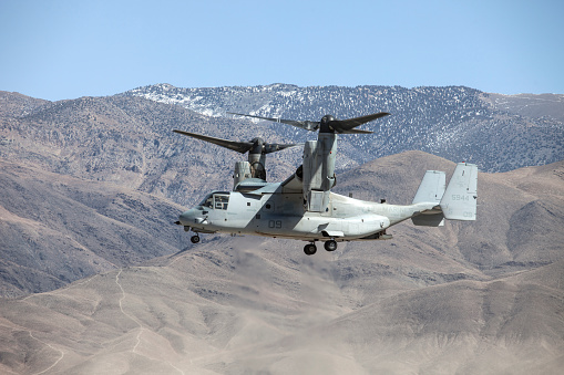 Bishop Airport (KBIH),Bishop California, USA, May 8, 2014.   United States Marine Corps Osprey MV-22 Aircraft from Marine Squadrons, VMM-161 and VMM-162 perform high altitude landing and launching training.\n\nBishop Airport, (KBIH)  was built in 1928 and expanded and operated by the Army Air Corps during WWII.  During the war it was used as a military flight training base and boasted a chow hall and barracks for pilots during training.  Because of its strategic location east of the 12,000 foot tall Sierra Nevada Mountain range Bishop would be used as a Fall Back Base in the event the Japanese military attacked the California coast. \n  \nToday the airport has multiple modern navigational aids and is used by civilian aircraft and all branches of the US military for training and fuel stops.  Bishop has a military fuel contract which allows any military aircraft to purchase fuel.  Because of its close proximity to the Marine Corps High Altitude Training Facility at Pickle Meadows, Bishop is a vital fuel stop.  Aircraft leave their bases on the California coast fully laden with troops and after depositing them at Pickle Meadows stop at Bishop for fuel.  \n\n Aircraft perform differently at higher altitudes than at sea level.  Performance is affected by altitude, weight and available power.  Fuel, cargo and passenger loads must be calculated based on altitude, weight and aircraft power.  On a 100 degree day at Bishop's 4,200 foot elevation an aircraft will perform as though it was launching from an airport located 8,000 feet above sea level.  This phenomena is known as Density Altitude.  During workups for deployment to Afghanistan military air units practice in and around the Bishop area because of the high elevation of the airport, sparse population and similarity of terrain.  Copyright Kenneth Babione