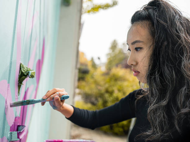 istock Female mural artist at work 1281303164