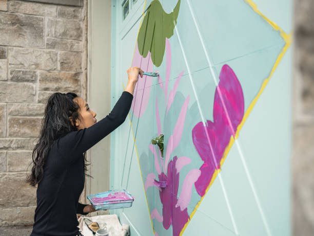istock Female mural artist at work 1281303316