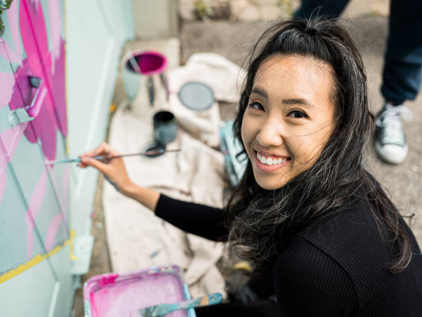 istock Female mural artist at work 1281303371