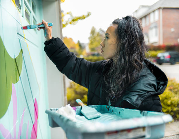 istock Female mural artist at work 1281303413