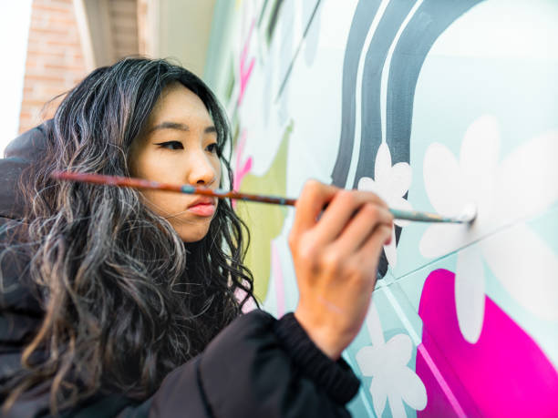 istock Female mural artist at work 1281304212