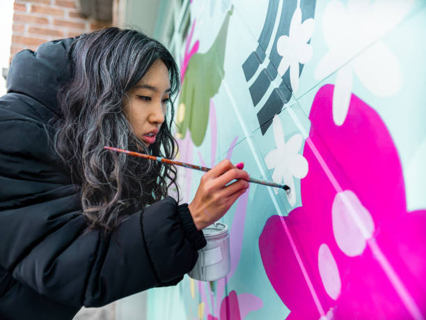 istock Female mural artist at work 1281304290