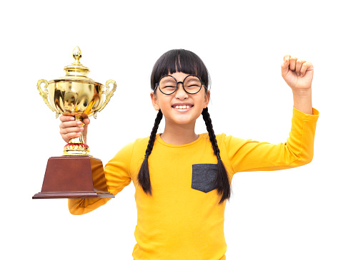 A young Asian girl held a gold trophy and expressed joyfully. Isolated on white background