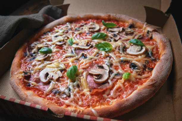 istock Pizza with Prosciutto Ham, Mushrooms and Fresh Basil 1281304864