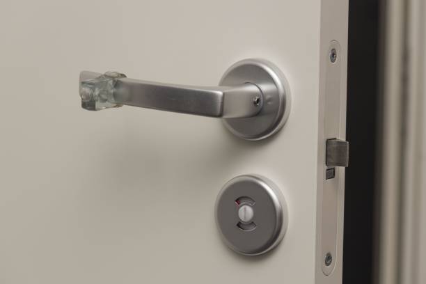 istock Close up view of lock and handle buffer rubber on white door. Interior design. Beautiful backgrounds. 1281306064
