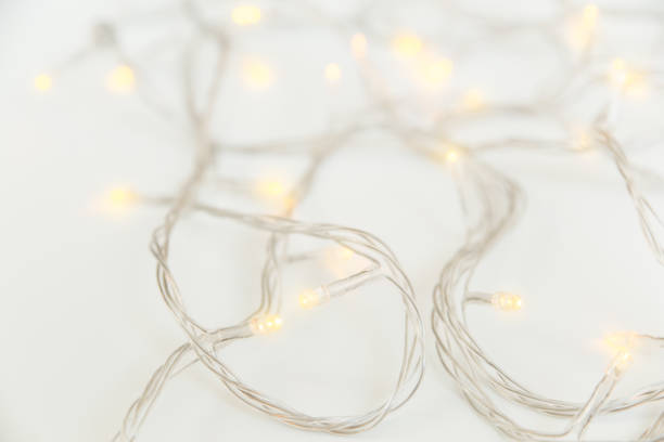 istock Christmas yellow light with white wire. White background. Close-up 1281306185