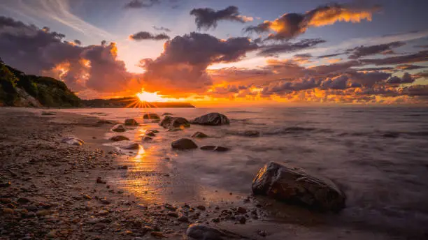 Colorful sunset over the sea and rocky shore