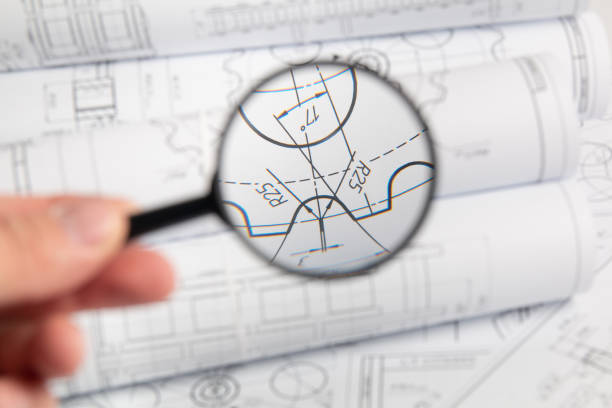 istock View of engineering drawings through a magnifying glass 1281310295