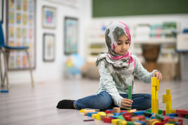 istock Playing with toy blocks on the classroom floor 1281312728
