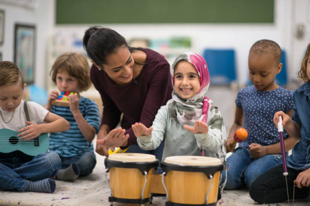 istock Kids having fun and playing music in class 1281312735