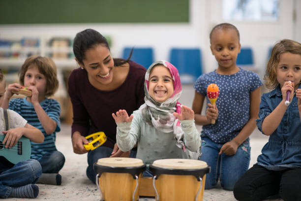 istock Kids having fun and playing music in class 1281312740