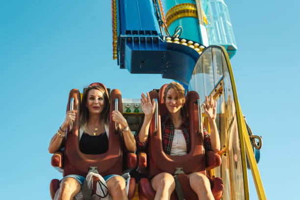 istock Two women at amusement park. 1281316352