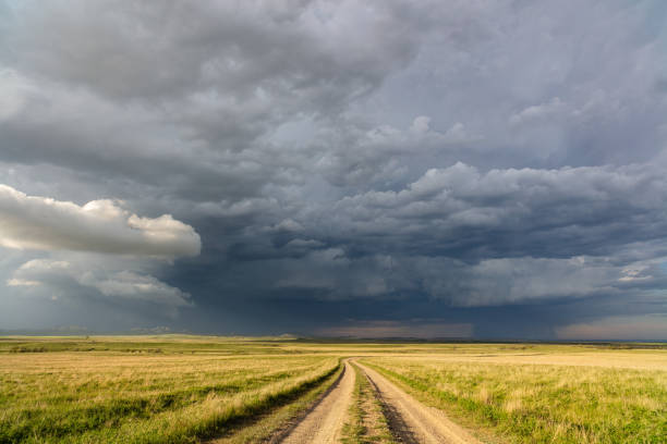 istock Winding dirt road with a stormy sky 1281319455
