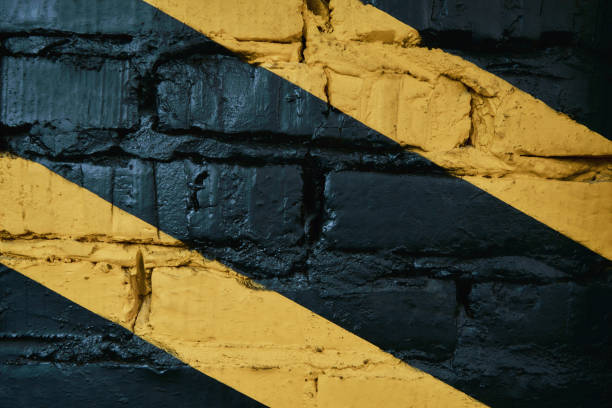 Black brick wall with yellow stripes at gym, background, copy space for text