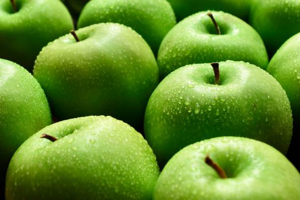 Green apples Apples on a wooden background green apple slice stock pictures, royalty-free photos & images