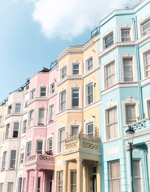 Colourful houses of Notting Hill Warm and pastel colours of houses in Notting Hill are a true gem of London. Cozy architectural style of buildings has become an attraction for tourists and film-makers. notting hill stock pictures, royalty-free photos & images