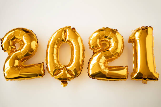 istock Number 2021 made from golden inflated balloons on a white table 1281322109