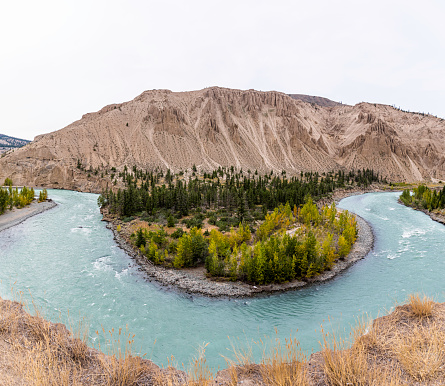 Looking across the Chilcotin River with the Hoodoos and sand dunes  on the fare bank.