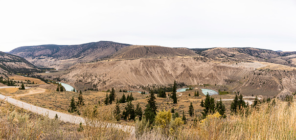 Looking across Farrell Canyon with the Chilcotin River running through it . The Hoodoos and sand dunes are on the fare bank of Farrell Canyon.