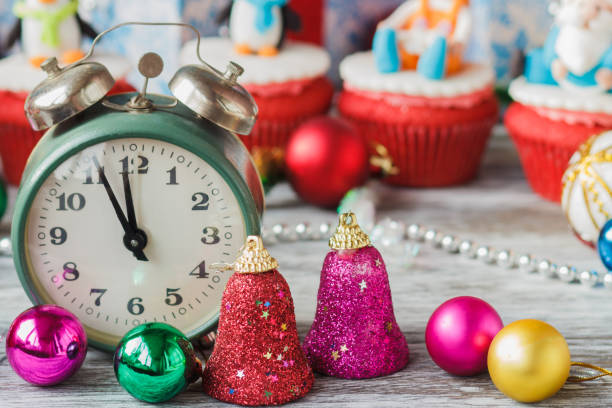 istock Old alarm clock near Christmas colored decorations 1281329411