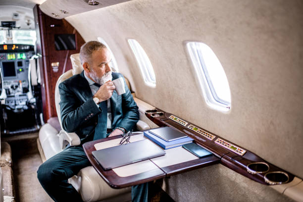 istock Businessman having cup of tea before work in his private jet 1281330493