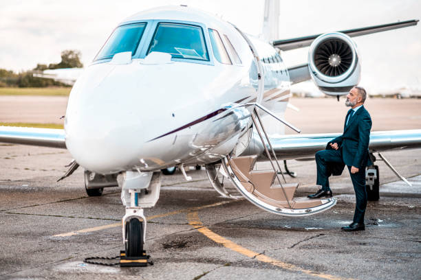 istock Businessman getting in a private jet airplane 1281330568