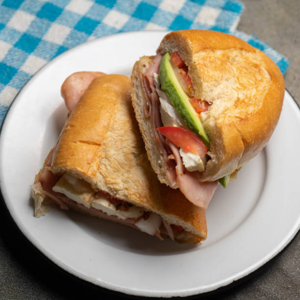 istock Mexican ham sandwich with avocado and cheese also called torta on dark background 1281331304