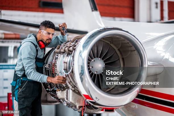 Aircraft Mechanic Checking Jet Engine Of The Airplane Stock Photo - Download Image Now
