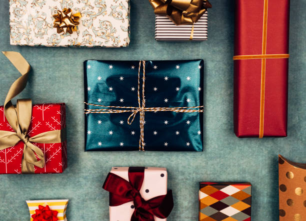 Merry Christmas: Colourful Christmas Presents in a Neat Flat Lay Composition Beautifully wrapped Christmas presents of various shapes and sizes in a flat lay still life. christmas present stock pictures, royalty-free photos & images