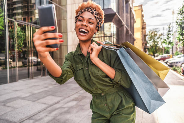 istock Pretty young lady having fun while shopping in the city 1281338777