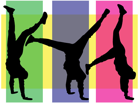 Silhouette of agile young man doing a handstand.