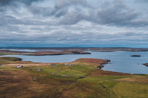 Aerial view of Westing on Unst Island in the Shetland Islands, Scotland. Pastures, buildings, farms and the North Atlantic.