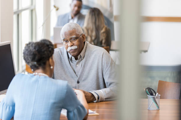 istock Concerned senior man talks with financial advisor 1281341025
