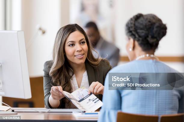 Bank Employee Explains Bank Services To New Customer Stock Photo - Download Image Now