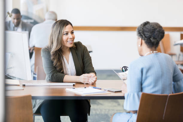 istock Confident banker talks with customer about banking customer 1281341048