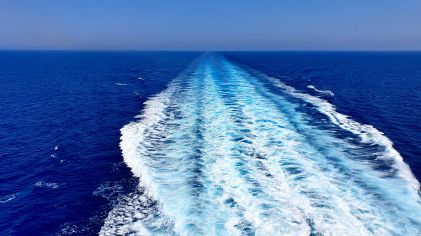 View of the wake of a cruise ship in the ocean. View of the wake of a cruise ship in the ocean. Perfect for any use. spume stock pictures, royalty-free photos & images