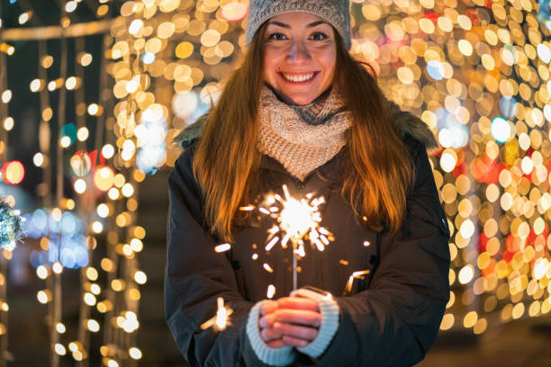 istock Woman lighting a sparkler candle 1281343457