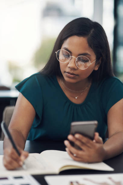 istock She's always planning, whether it be on paper or her phone 1281344131