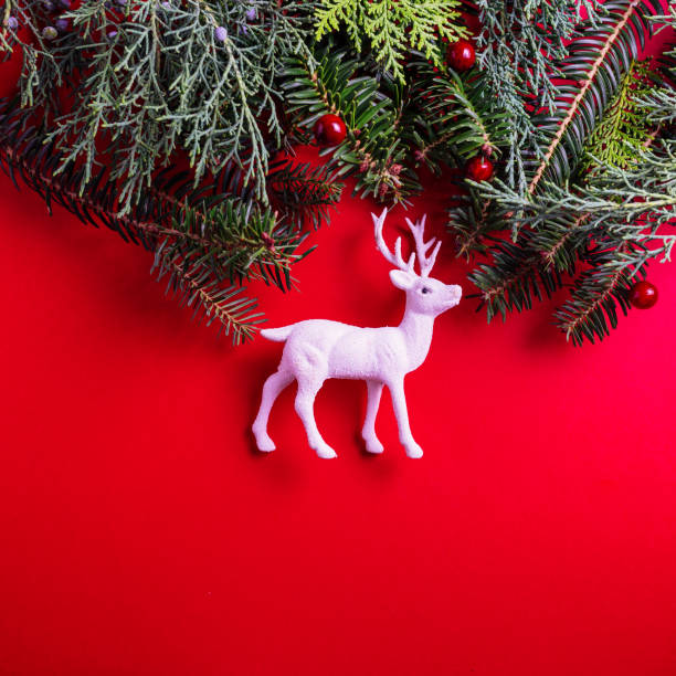 istock Creative layout made of Christmas tree branches and white Christmas reindeer 1281345064