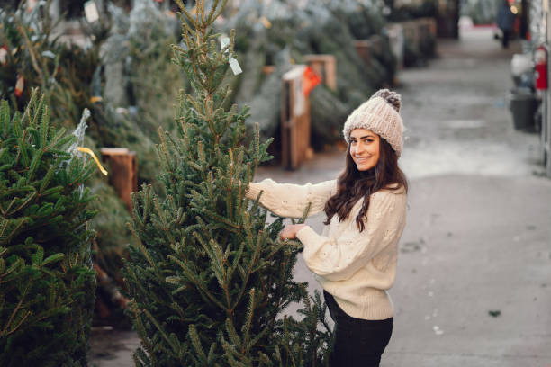 istock Cute brunette in a white sweater with Christmas tree 1281346352
