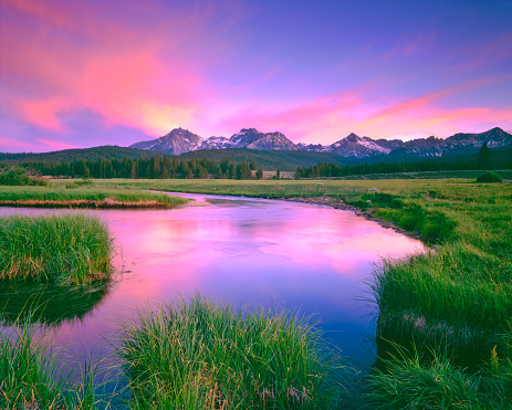 CLAM WATER OF VALLEY CREEK REFLECTS THE SAWTOOTH RANGE AT DUSK, STANLEY IDAHO