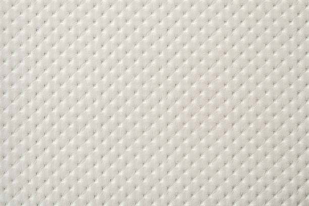 White perforated furniture upholstery leather texture. Embossing punto white sample of leatherette. White perforated furniture upholstery leather texture. Embossing punto white sample of leatherette. punto stock pictures, royalty-free photos & images