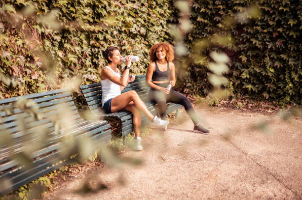 istock Two young female athletes relaxing after workout. 1281351028