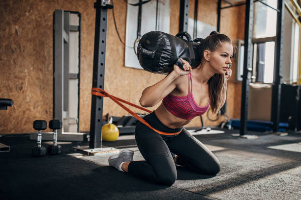 One fit woman working out with gym bag