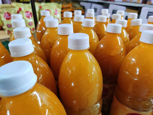 istock Mango juice packed softdrinks bottle closeup view in market for sale. 1281353408