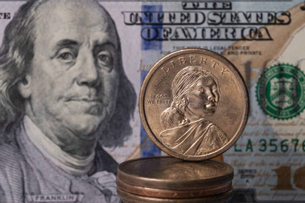istock Metal dollar and 100 dollar bill 1281354344
