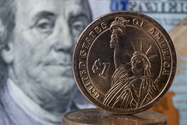 istock Metal dollar and 100 dollar bill 1281354350